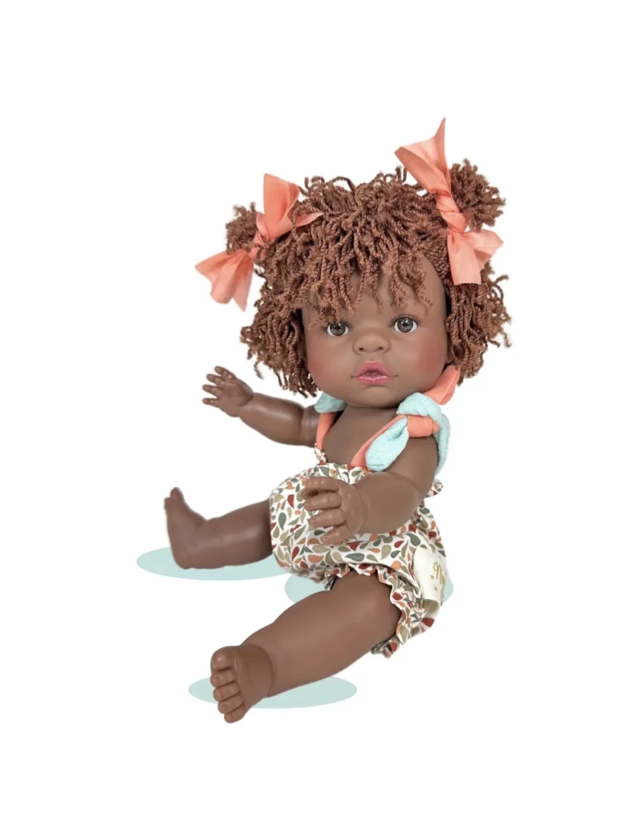 Doll with curly hair and floral outfit on a white background
