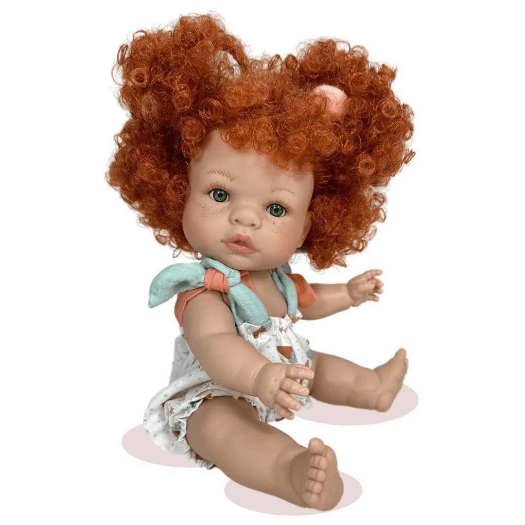 Baby doll with curly red hair and a light outfit on a white background