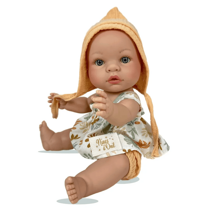 Baby doll wearing a hooded outfit with a white label on a white background
