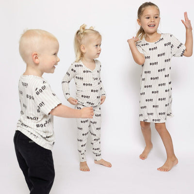 Three children wearing matching pajamas with text on a white background