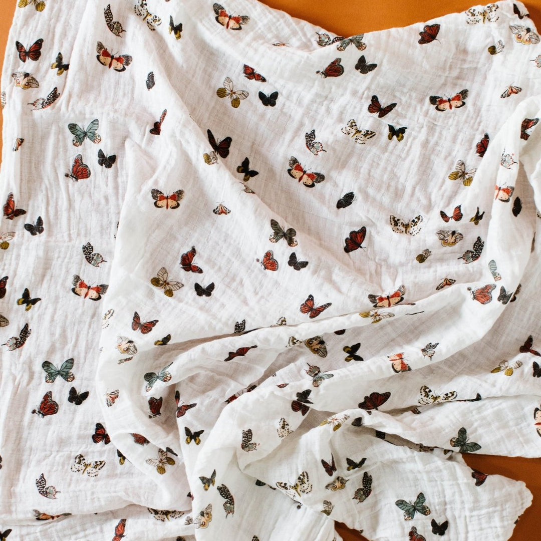 White fabric with butterfly pattern on an orange background