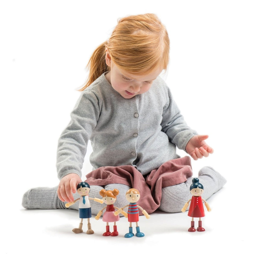 Child playing with toy figures on a white background