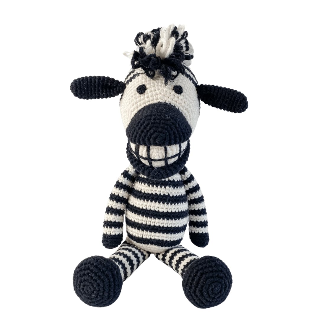 Crocheted zebra toy with black and white stripes on a white background