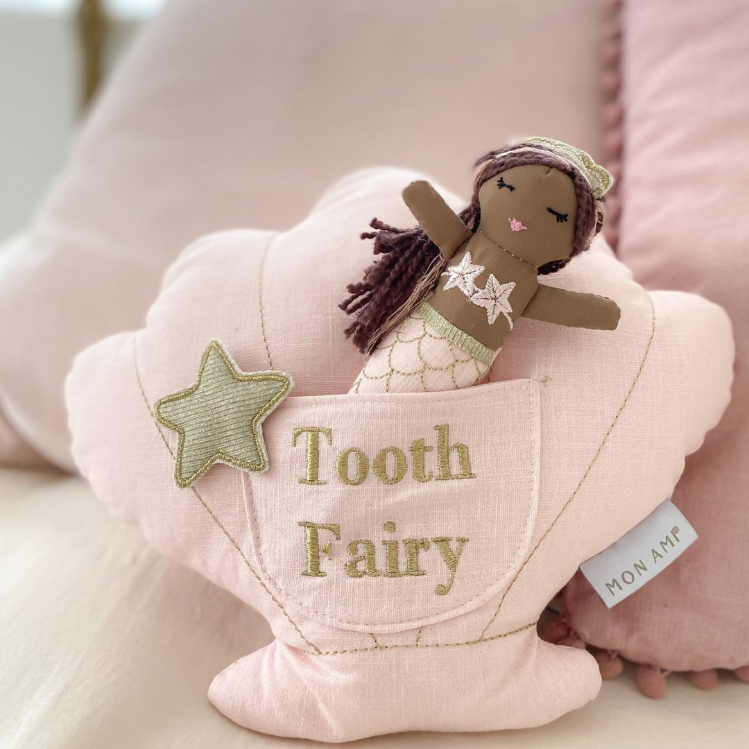 A pink shell-shaped tooth fairy pillow with a small mermaid doll inside, featuring a &
