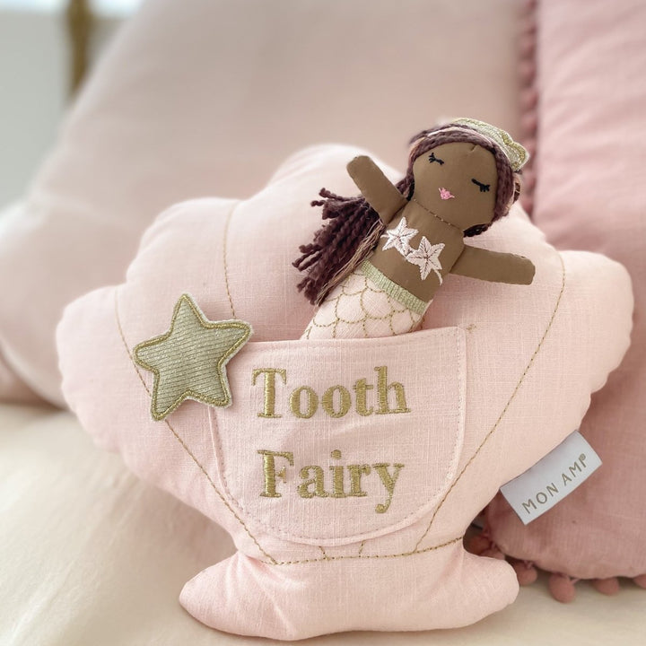 A pink shell-shaped tooth fairy pillow with a small mermaid doll inside, featuring a &
