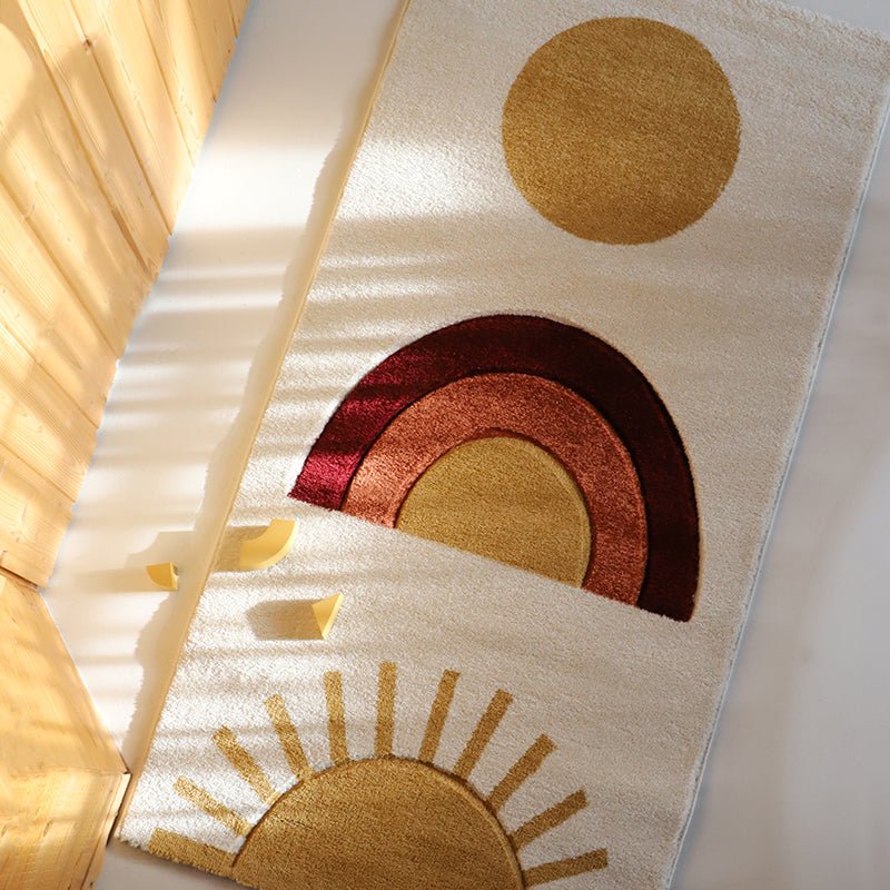 Decorative rug with sun and rainbow design on a light background