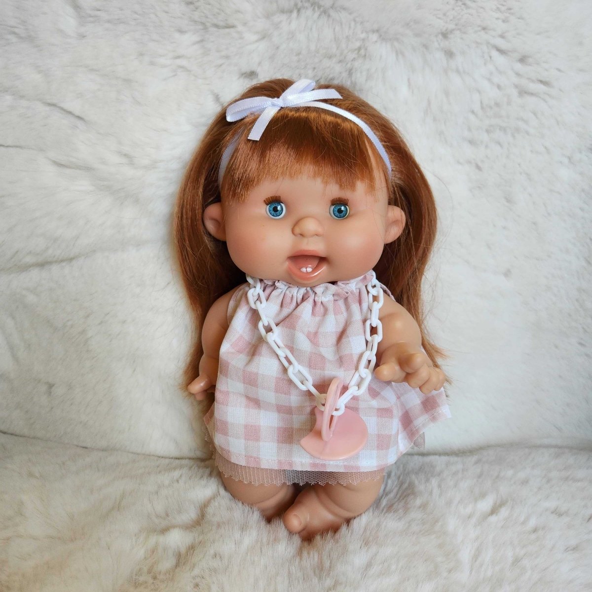 Pepote with red hair and blue eyes wearing a checkered dress