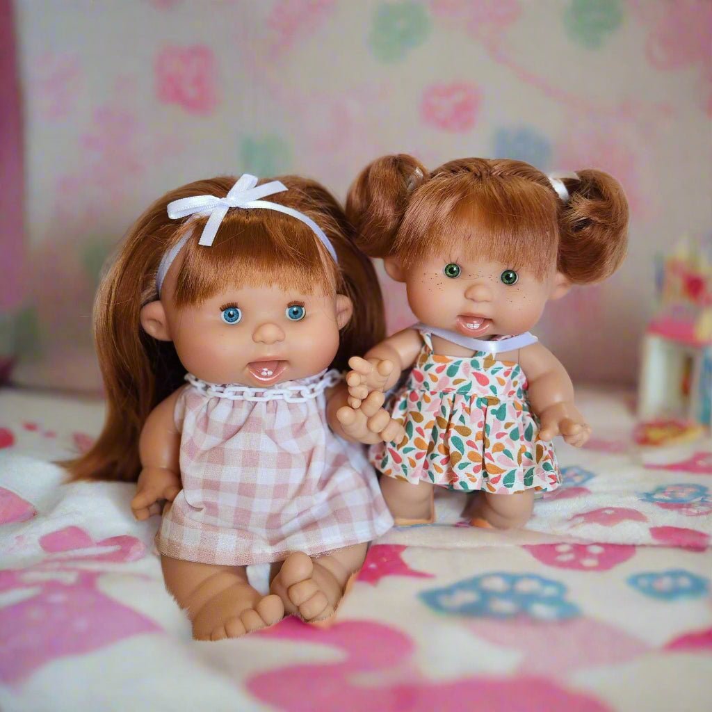 Two dolls with red hair, big sister and little sister.
