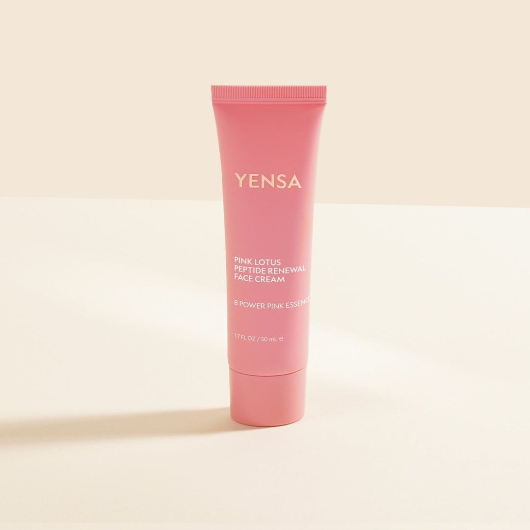 Pink tube of YENSA cream on a beige background