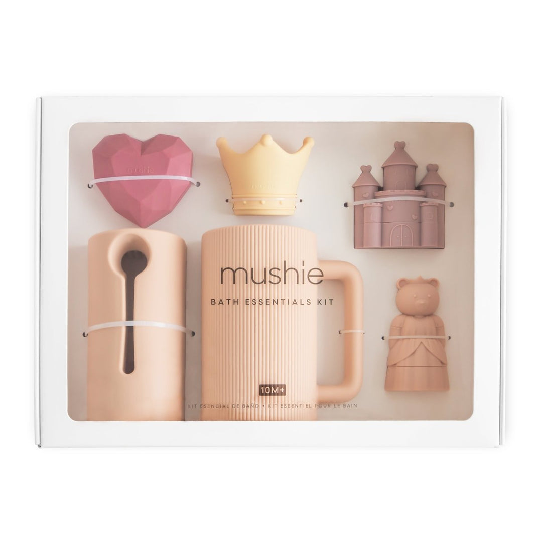 Mushie bath essentials kit packaging with various bath toys on a white background