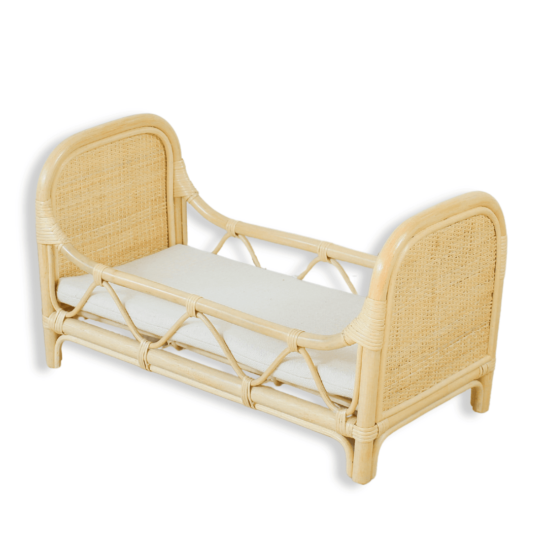 Wicker bed with a white mattress on a white background