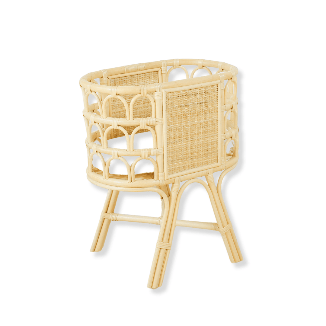 Wicker baby doll crib on a white background