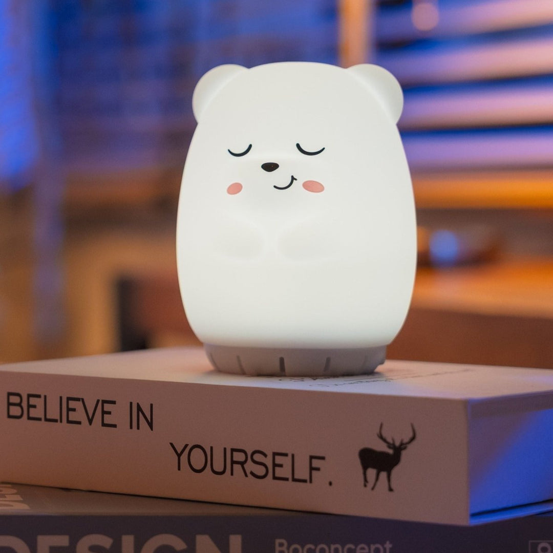 White bear-shaped night light on a box with 'Believe in Yourself' text, blurred background