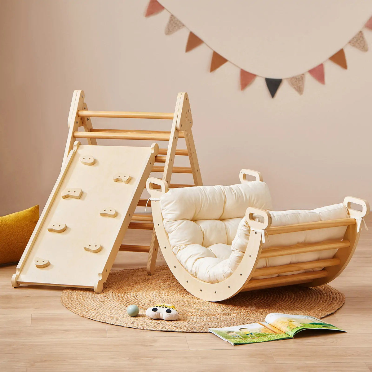 Children's play area with wooden climbing toy, swing, and toys on a wooden floor.