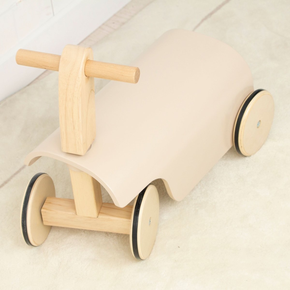 Wooden toy car with a seat on a light background
